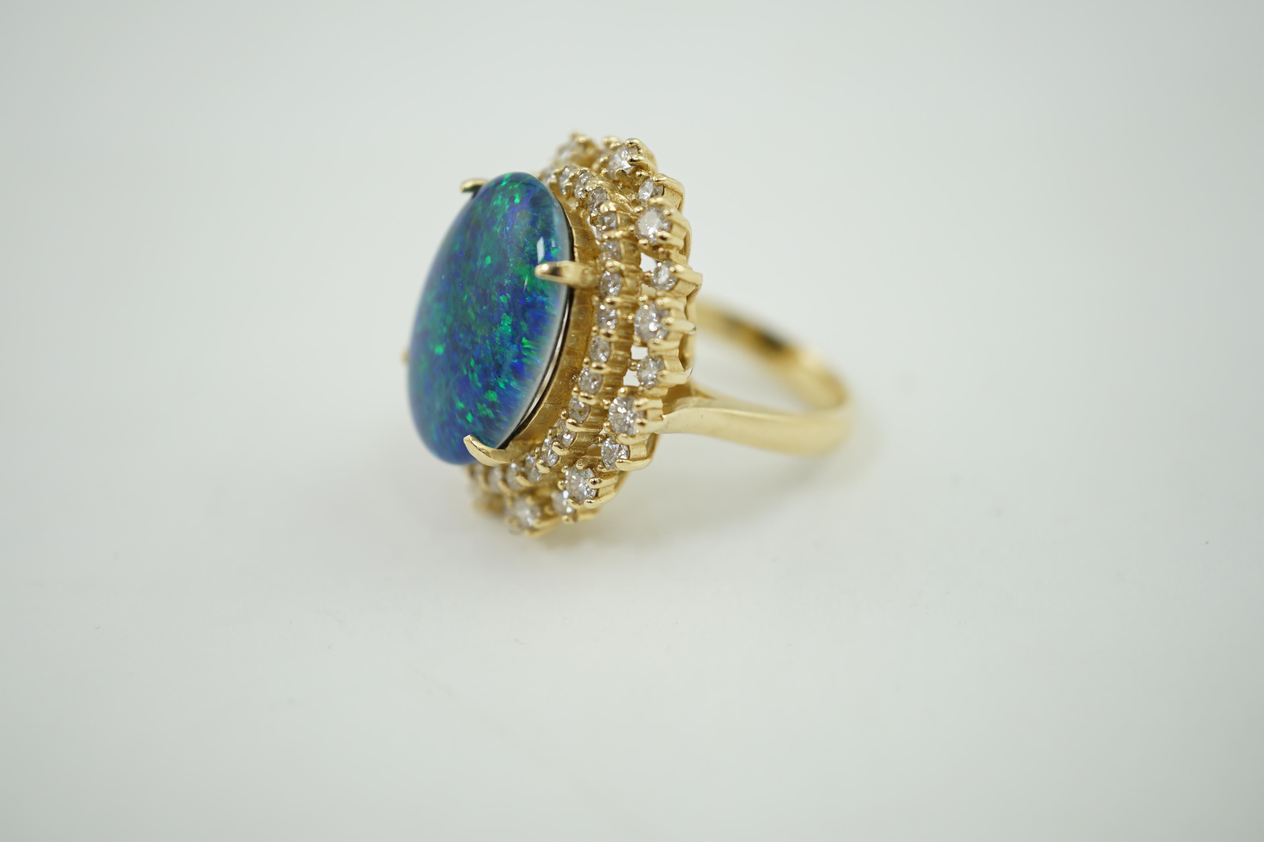 A modern American 14k gold, black opal doublet and diamond cluster set oval dress ring